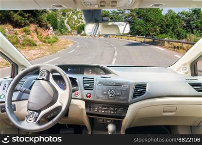 car windscreen with country road, view inside out. car windscreen with road