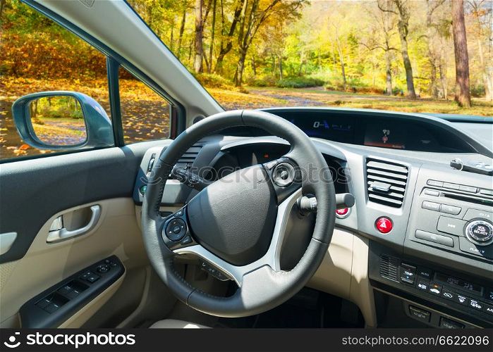 car windscreen with fall road, view inside out. car windscreen with road