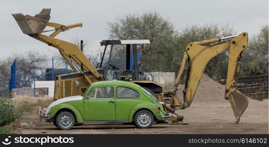 Car with excavator at construction site, Los Olivos, Dolores Hidalgo, Guanajuato, Mexico