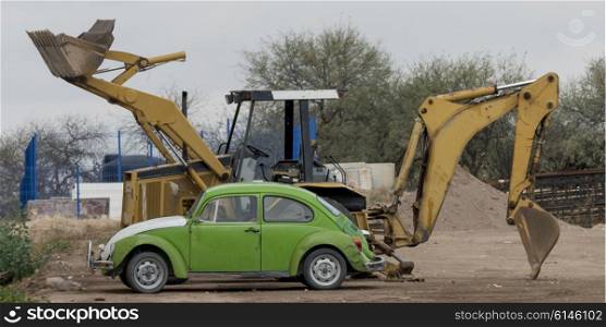 Car with excavator at construction site, Los Olivos, Dolores Hidalgo, Guanajuato, Mexico