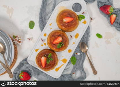 Caramel custard pudding on plate over modern background with copy space. Top view, flat lay