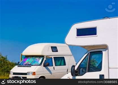 Caravan and campervan camping on nature in summer. Traveling by motor home. Caravan vacation.. to Camper cars camping on nature