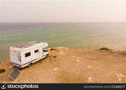 Caravan c&ing on cliff sea shore. Mediterranean region of Mazarron in Murcia Spain.. C&er car on coast, Murcia Spain