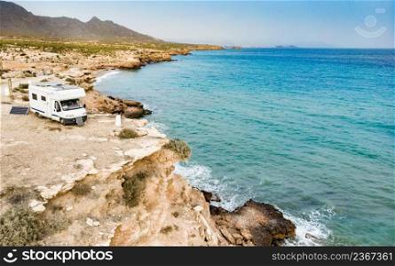 Caravan camping on cliff sea shore. Mediterranean region of Mazarron, Sierra de las Moreras in Murcia Spain.. Camper car on coast, Murcia Spain