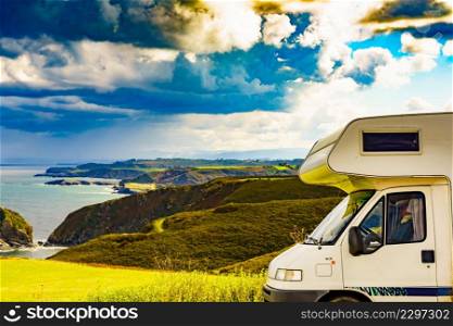 Caravan camping on sea coast in north Spain. View from Faro de Cabo Penas to the Bay of Biscay. Seascape of Atlantic ocean and Asturias coastline.. Camper car on sea coast in Asturias Spain.