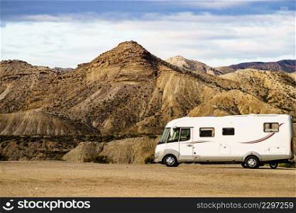 Caravan recreational vehicle c&ing in Tabernas desert, Almeria Spain. Traveling with motorhome.. C&er vehiclein Tabernas desert, Spain