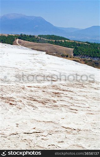 Carbonate travertines with blue water - unique nature wonder in Pamukkale, Turkey