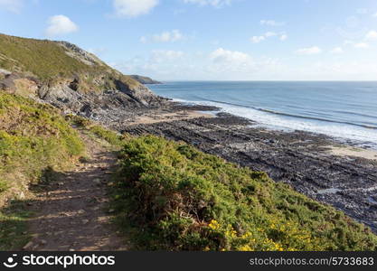 Carboniferous limestone forms a rough limestone pavement at a beach beside the Wales Coast Path, near Caswell Bay, Gower.