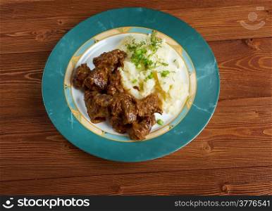 carbonnade de boeuf a la Flamande with mashed potatoes. traditional Belgian sweet-sour beef and onion stew made with beer, and seasoned with thyme, bay and mustard.
