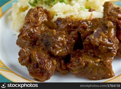 carbonnade de boeuf a la Flamande with mashed potatoes. traditional Belgian sweet-sour beef and onion stew made with beer, and seasoned with thyme, bay and mustard.