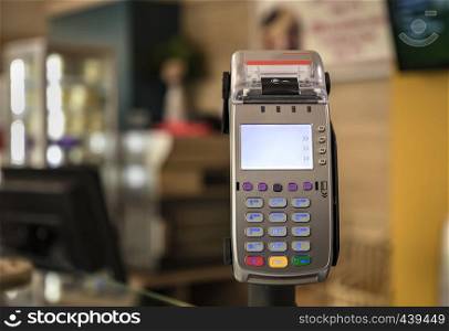 card payment terminal POS terminal at a shop, close up. Blurred background