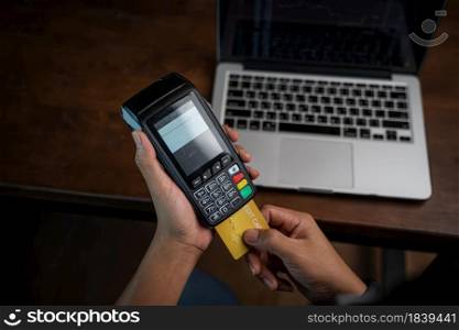 Card with contactless technology,Payment transaction with card,Online payment,Man hands holding a credit card and using smart phone for online shopping,Online shopping concept.