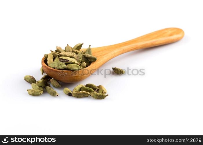 Cardamom in wooden spoon isolated on a white background