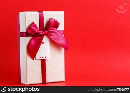 cardboard biodegradable gift box with bows on red background