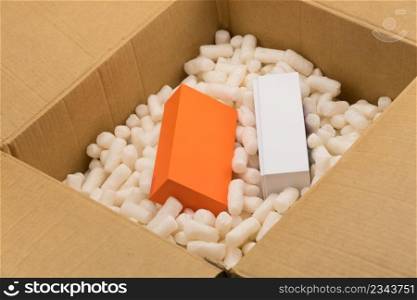 Cardboard box with styrofoam filler for safe packaging. Gift package. Filler for packaging