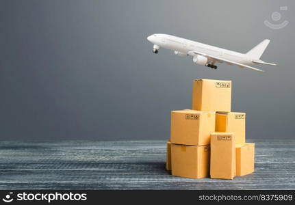 Cardboard boxes and freight airplane. International delivery distribution of goods and products. Logistics, infrastructure hubs. Import, export. Economic relations commerce. Air transportation.