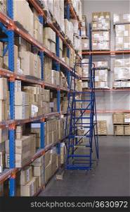 Cardboard boxes on shelves in distribution warehouse