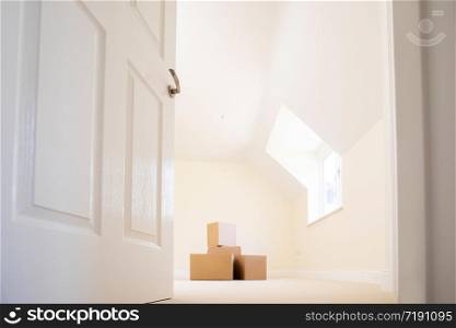 Cardboard Boxes Stacked In New Home On Moving Day