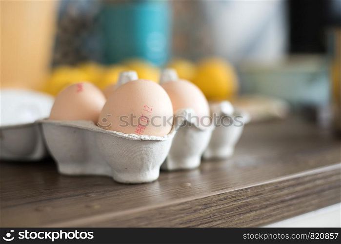 Cardboard of fresh free-range eggs in the kitchen