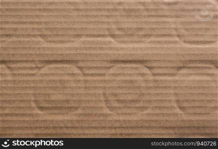 Cardboard texture background with round patterns on it in the view