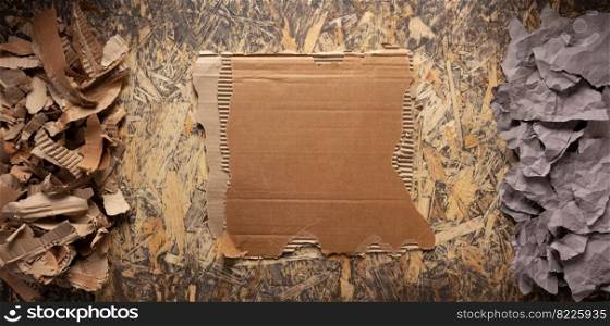 Cardboard torn edge and brown ripped paper at chipboard plywood background texture. Recycling concept and waste paper