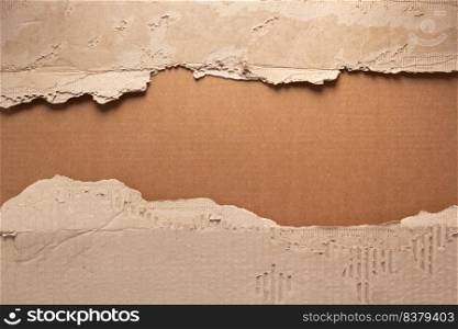 Cardboard torn edge as background texture. Brown ripped paper