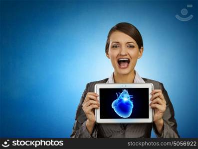Cardiology concept. Young businesswoman showing tablet pc against heart