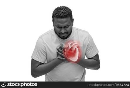 cardiology, healthcare and medicine concept - sick african american man suffering from heart ache over white background. african american man suffering from heart ache