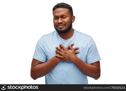 cardiology, healthcare and problem concept - sick african american man suffering from heart ache over white background. african american man suffering from heart ache