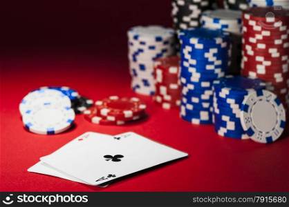cards and poker chips on a red cloth