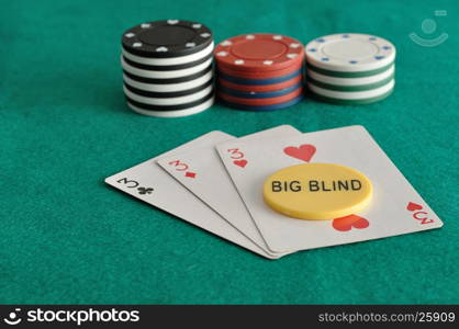 Cards with poker chips and the big blind chip