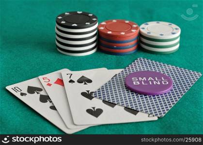 Cards with poker chips and the small blind chip