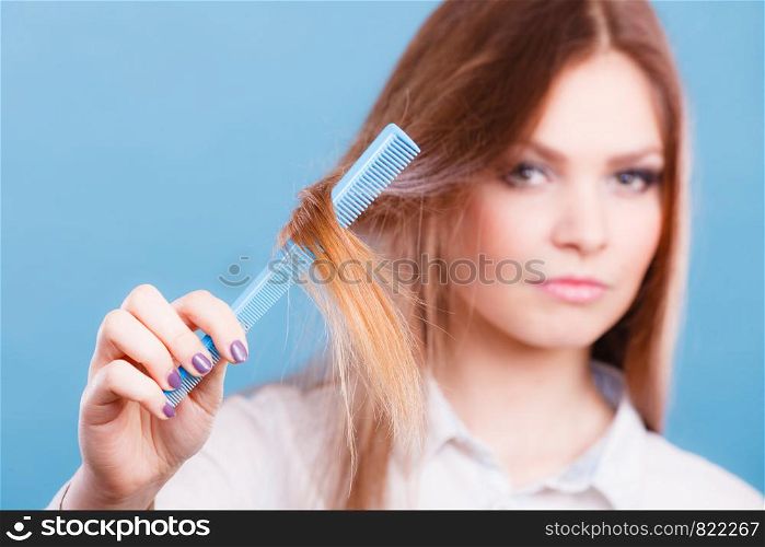 Care coiffure haidressing professional beauty concept. Girl with comb. Young smiling lady combing hairs changing haistyle.. Girl with comb.