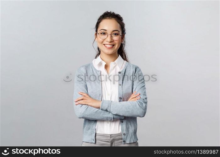 Career, business and education concept. Portrait of cheerful asian girl ready to start online lesson with students, explain class new theme, cross hands chest confident, smiling self-assured.. Career, business and education concept. Portrait of cheerful asian girl ready to start online lesson with students, explain class new theme, cross hands chest confident, smiling self-assured