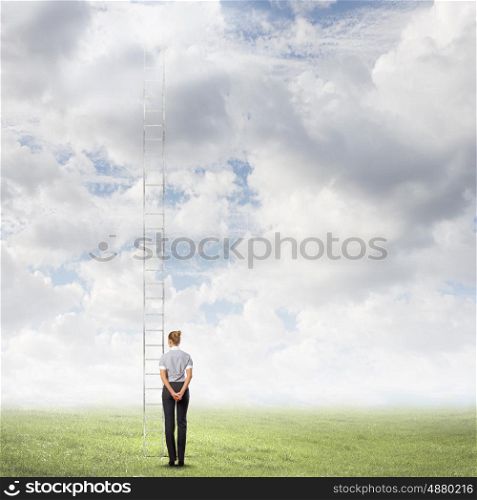 Career ladder. Rear view of businesswoman standing near ladder going high in sky