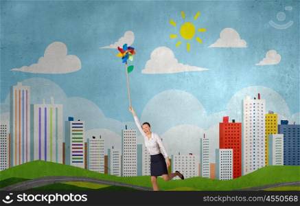 Carefree and happy. Beautiful young caucasian businesswoman flying on windmill