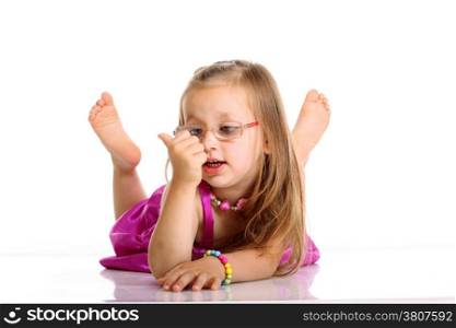 Carefree days of childhood. Cute little girl lying on floor counting with fingers studio shot isolated on white background
