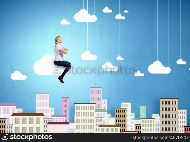 Carefree girl. Young pretty girl riding on cloud high in sky