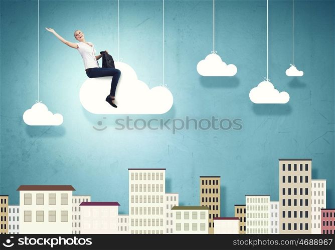 Carefree girl. Young pretty girl riding on cloud high in sky