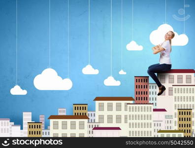 Carefree girl. Young pretty girl sitting on building roof