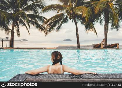 Carefree woman relaxation in swimming pool summer Holiday concept