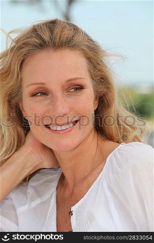 Carefree woman relaxing on a sunny breezy day