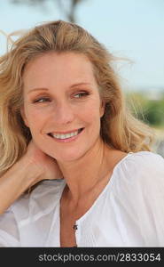 Carefree woman relaxing on a sunny breezy day