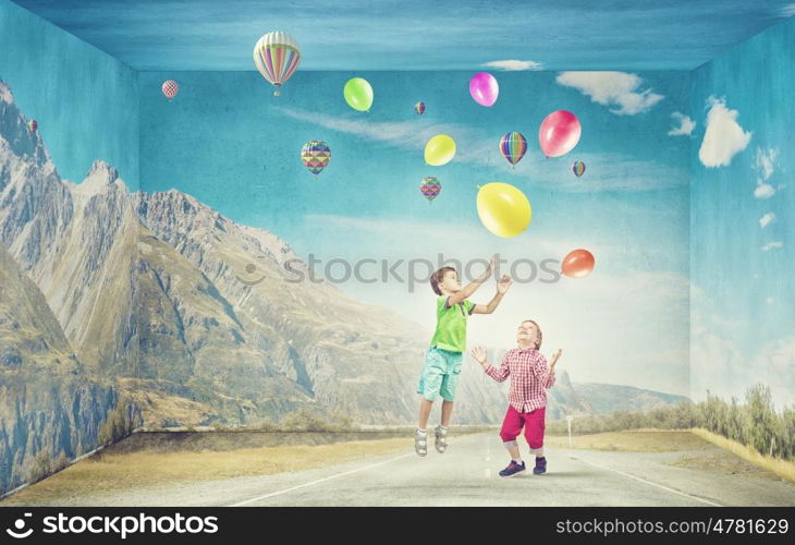 Careless happy children. Little cute boys playing joyfully with colorful balloon