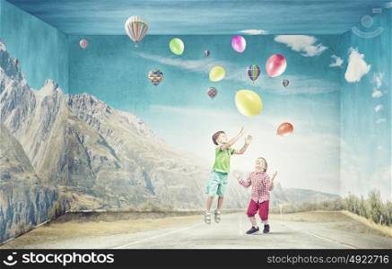 Careless happy children. Little cute boys playing joyfully with colorful balloon