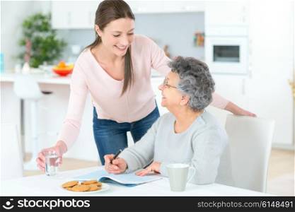 Carer helping woman at home