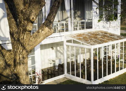 Cargo container cafe with wooden furniture set, stock photo