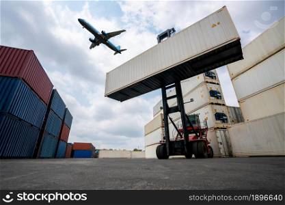 Cargo container for overseas shipping in shipyard with airplane in the sky . Logistics supply chain management and international goods export concept .. Cargo container for overseas shipping in shipyard with airplane in the sky .