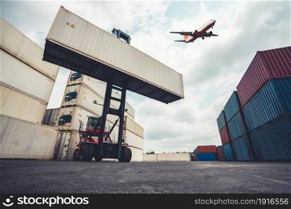 Cargo container for overseas shipping in shipyard with airplane in the sky . Logistics supply chain management and international goods export concept .. Cargo container for overseas shipping in shipyard with airplane in the sky .