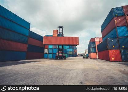 Cargo container for overseas shipping in shipyard with heavy machine . Logistics supply chain management and international goods export concept .. Cargo container for overseas shipping in shipyard with heavy machine .
